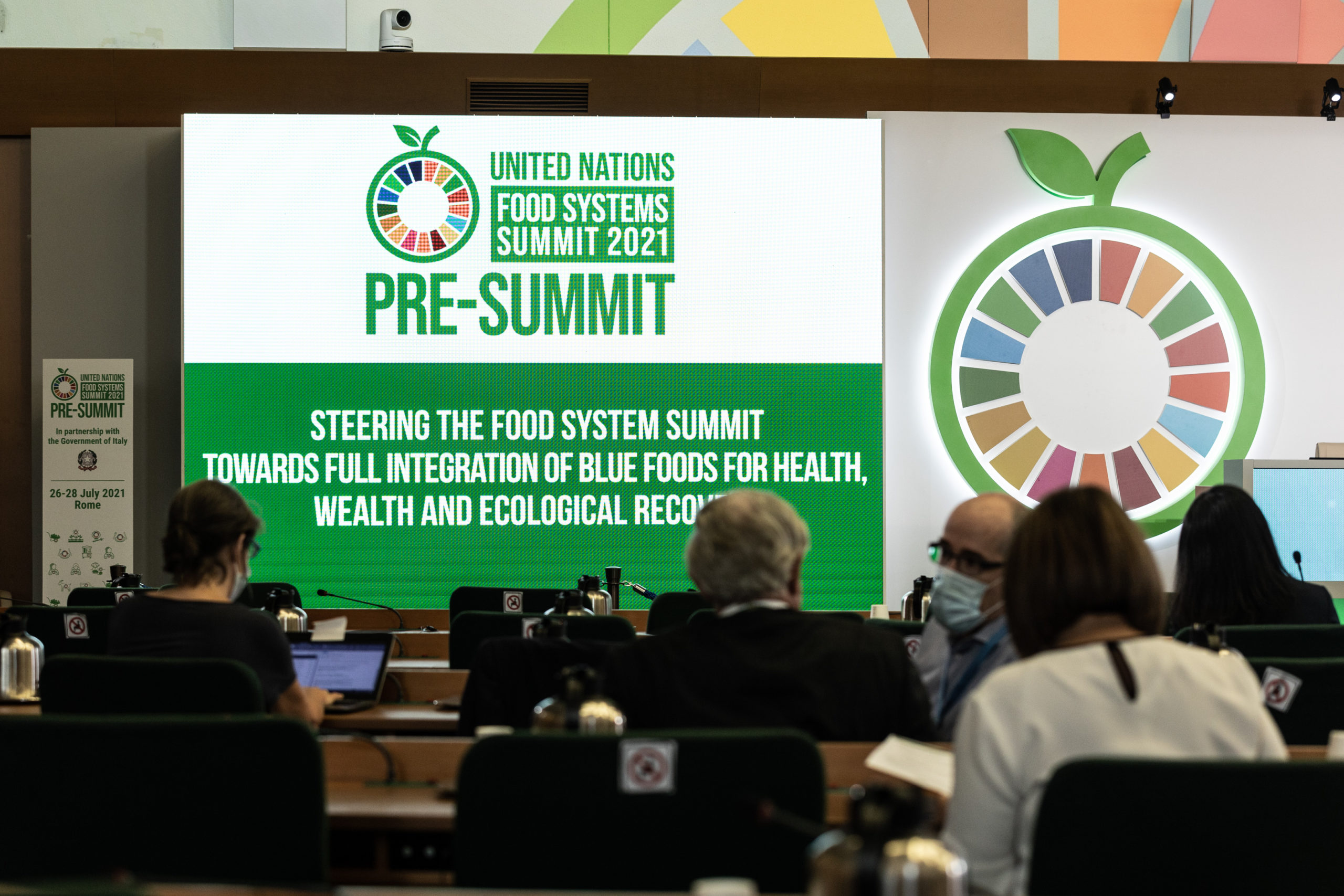 People wait in event venue for the Pre-Summit of the United Nations Food System Summit 2021