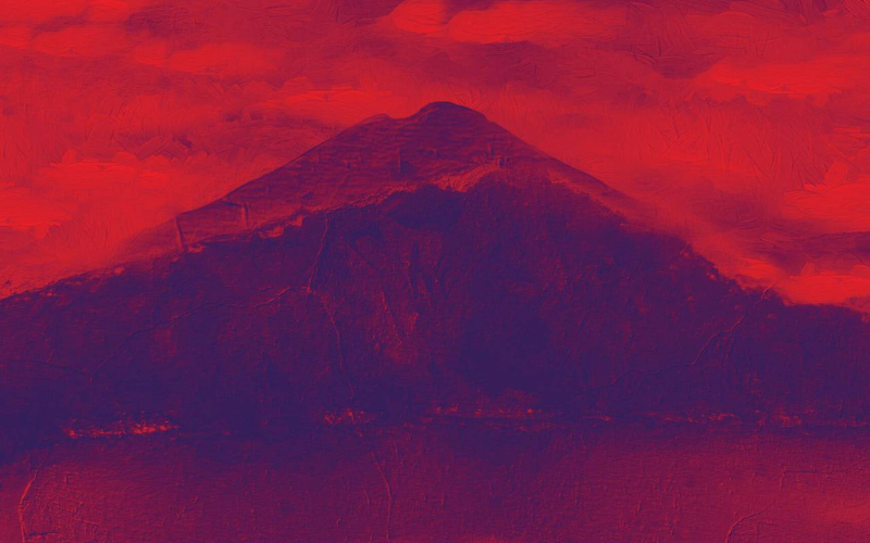 Watercolor-like image of dark purple mountain shaded by red clouds.