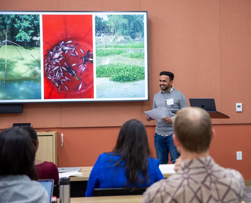 A person presents to an audience.