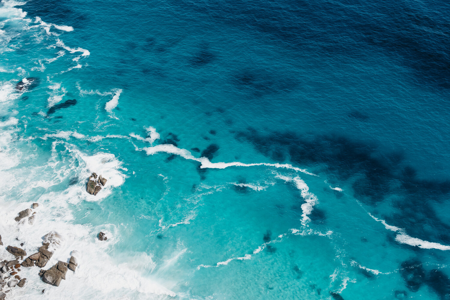 Aerial view of turquoise ocean.